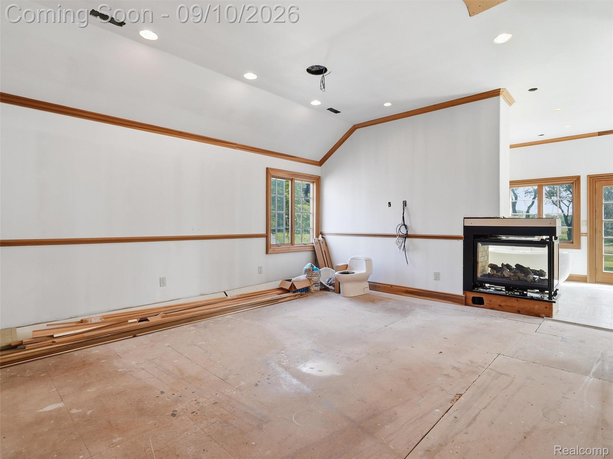 61400 Romeo Plank Road Ray, MI 48096 - Photo 57 of 99 Vaulted ceiling with recessed lighting, wood-trimmed windows, and a built-in fireplace