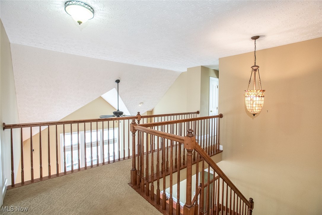 630 Rundle Street Lagrange, OH 44050 - Photo 41 of 49 Hallway featuring a textured ceiling, carpet, and vaulted ceiling