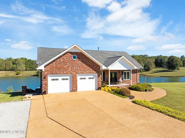 a view of a house with a yard and sitting area
