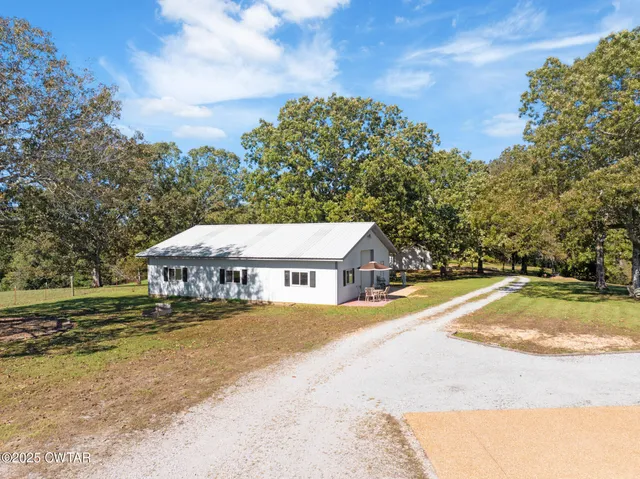 an aerial view of a house with a lake view