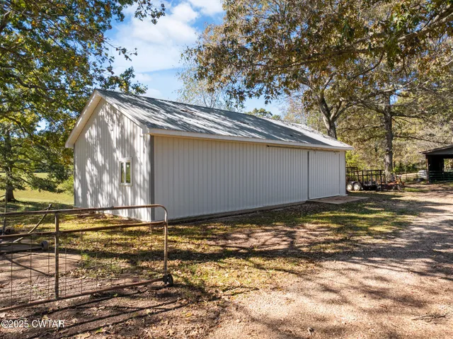 a living room with lots of furniture and a large window