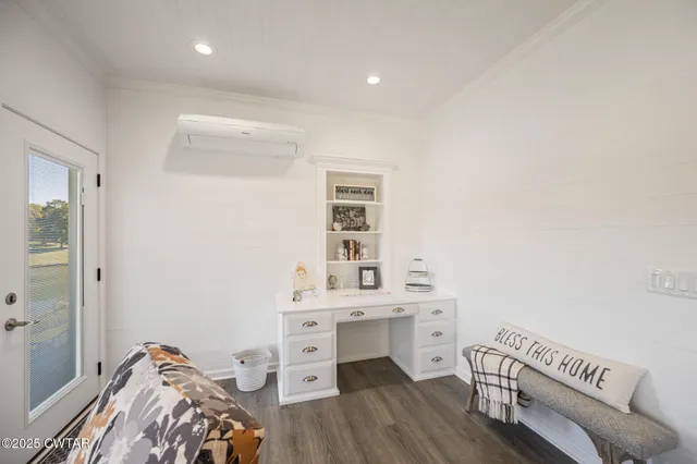 a view of a livingroom with furniture and a window