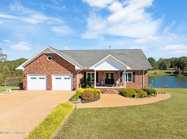 a view of a lake with couches and city view