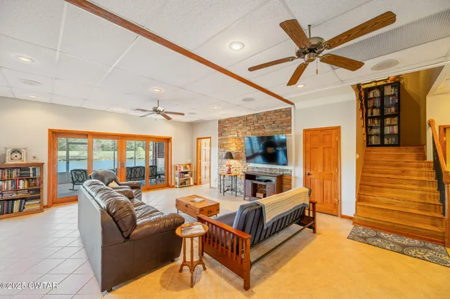 a living room with furniture and a floor to ceiling window