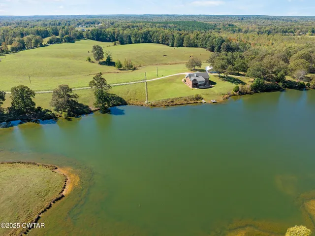 a swimming pool with outdoor seating and yard