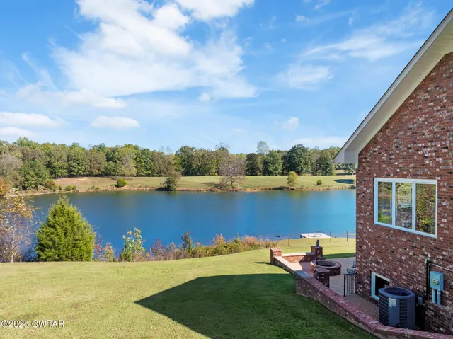a view of a swimming pool and a yard