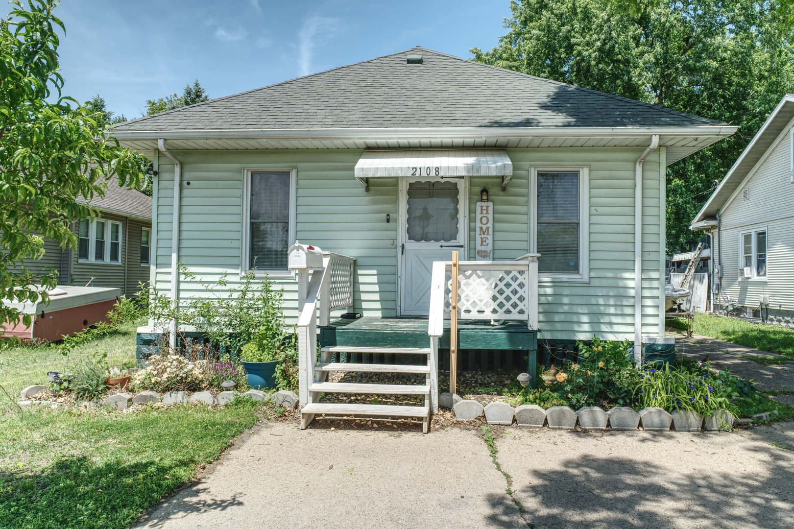 2108 Camanche Avenue Clinton, IA 52732 - Photo 1 of 22 a front view of a house with a garden