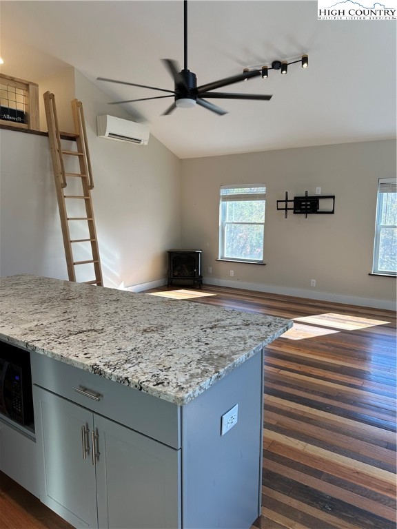 3242 Howard's Creek Road Boone, NC 28607 - Photo 12 of 33 a view of a kitchen island a sink wooden floor and a window