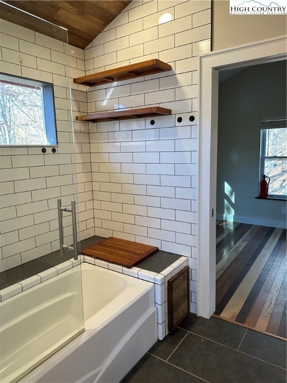 3242 Howard's Creek Road Boone, NC 28607 - Photo 13 of 33 a bathroom with a sink and a bathtub