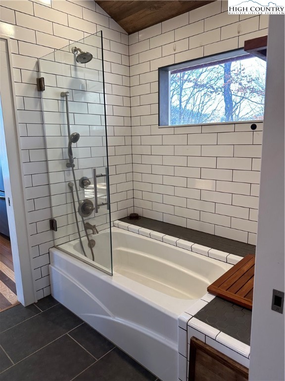 3242 Howard's Creek Road Boone, NC 28607 - Photo 14 of 33 a bathroom with a bathtub and a shower
