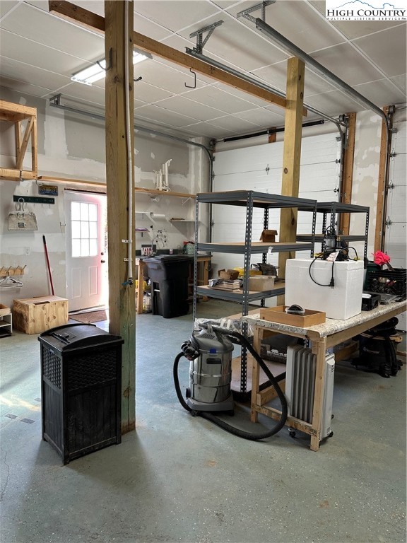 3242 Howard's Creek Road Boone, NC 28607 - Photo 22 of 33 a living room with furniture a flat screen tv and large windows