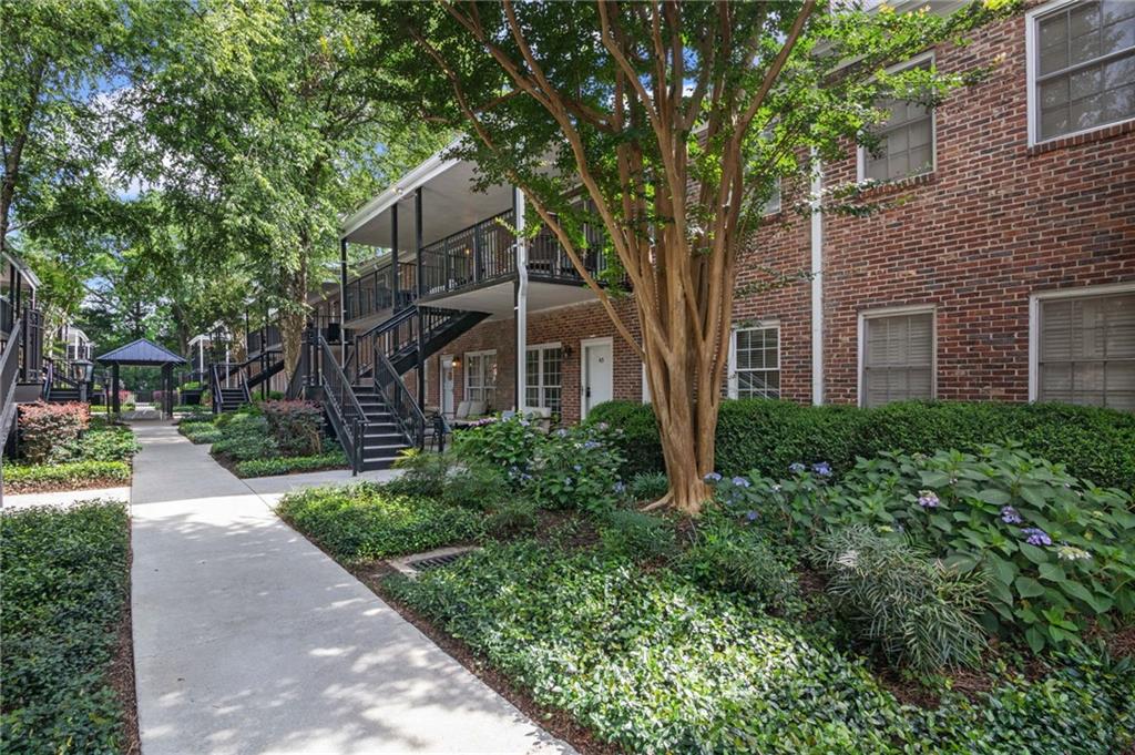 3675 Peachtree Road Northeast, Unit 45 Atlanta, GA 30319 - Photo 32 of 42 a front view of a house with garden