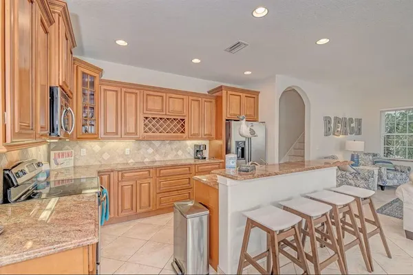 a kitchen with stainless steel appliances granite countertop a sink and cabinets