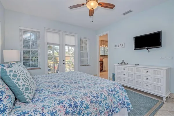 a bedroom with a bed and a flat screen tv