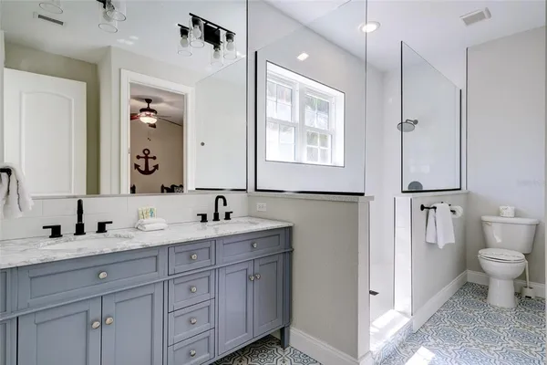 a bathroom with a toilet sink double and mirror