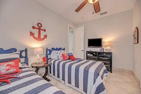 a bedroom with a bed and a flat screen tv