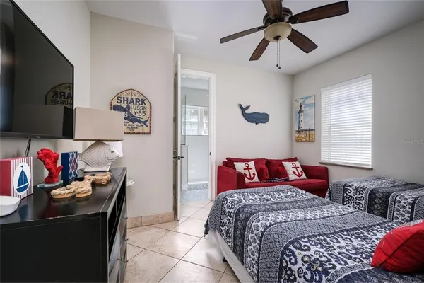 a bedroom with a bed and a chandelier