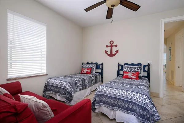 a bedroom with two beds and a chandelier