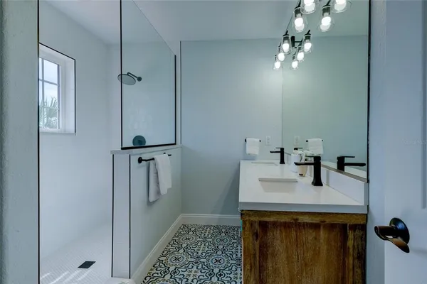 a bathroom with a sink a mirror and vanity