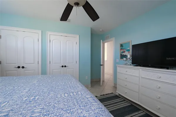 a bedroom with a bed and flat screen tv
