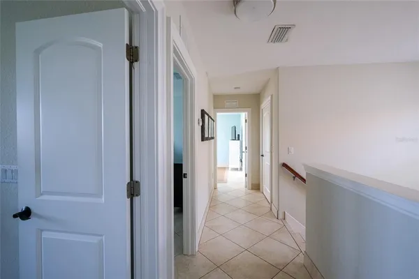 a view of a hallway with a wooden cabinets