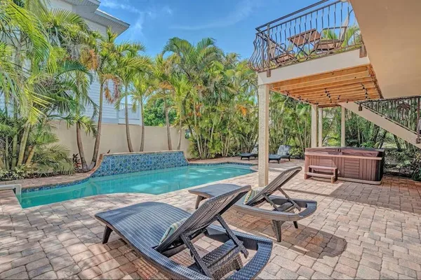 a view of a backyard with sitting area