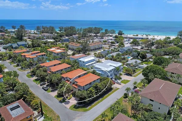 an aerial view of residential houses with outdoor space