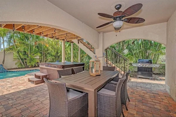 a view of a patio with a table chairs and a backyard