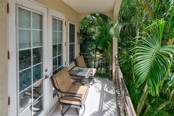 a view of a chair and table in backyard of the house