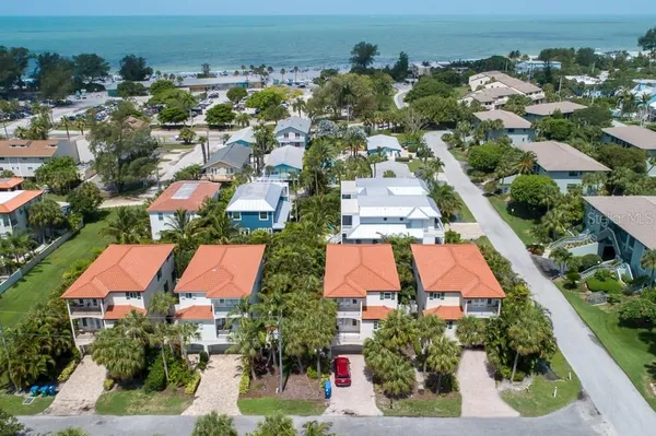 an aerial view of residential houses with outdoor space and swimming pool