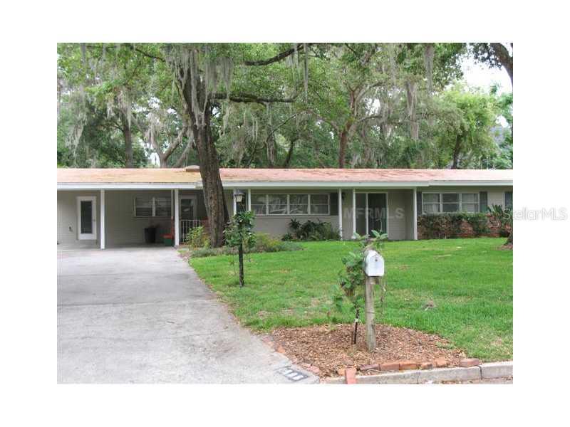 1906 Stonehurst Road Winter Park, FL 32789 - Photo 1 of 1 a front view of a house with a yard