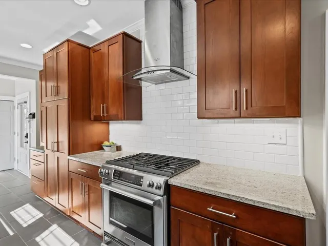 a kitchen with stainless steel appliances granite countertop a stove and a refrigerator