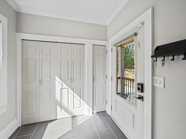 a view of a hallway with windows and entryway