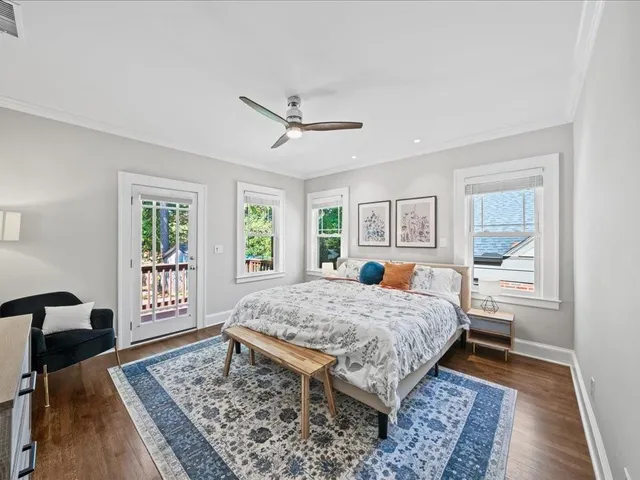 a living room with a bed furniture and next to a window