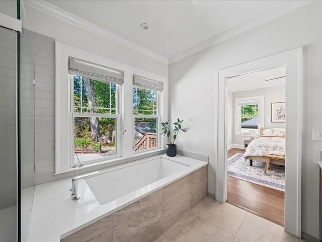 a spacious bathroom with a tub and shower