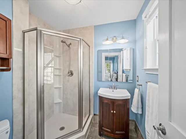 a bathroom with a sink a mirror and a shower