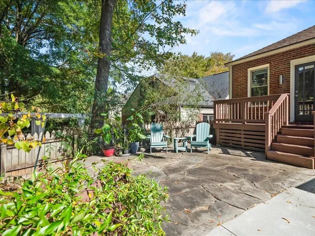 a view of a chair and table in the backyard