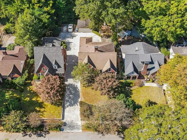 an aerial view of a house with a yard swimming pool and outdoor seating
