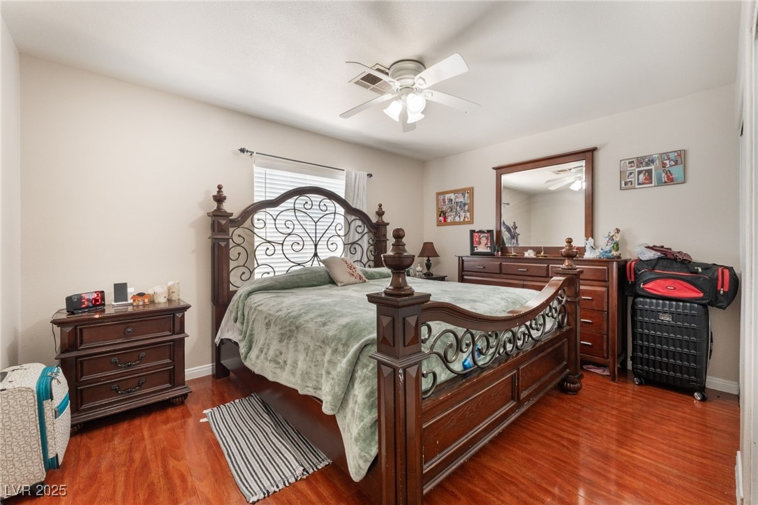 4656 East Desert Inn Road Las Vegas, NV 89121 - Photo 49 of 98 4650 E DI Bedroom with wood finished floors and a ceiling fan