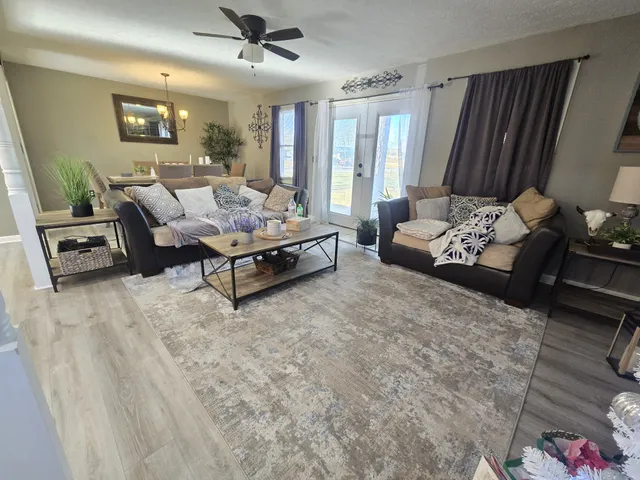 a living room with furniture rug and window