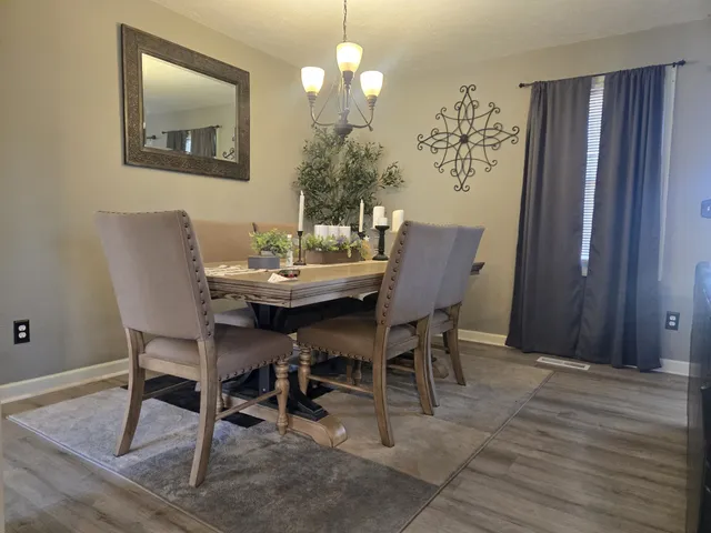 a dining room with furniture and window