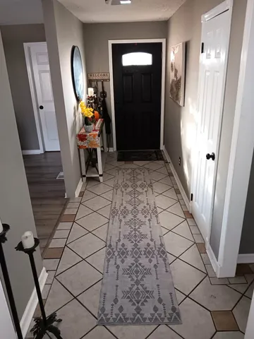 a view of an entryway with wooden floor