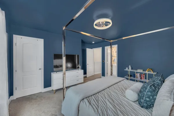 a bedroom with a bed and a large window