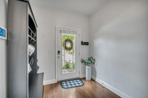 an empty room with windows and painted walls