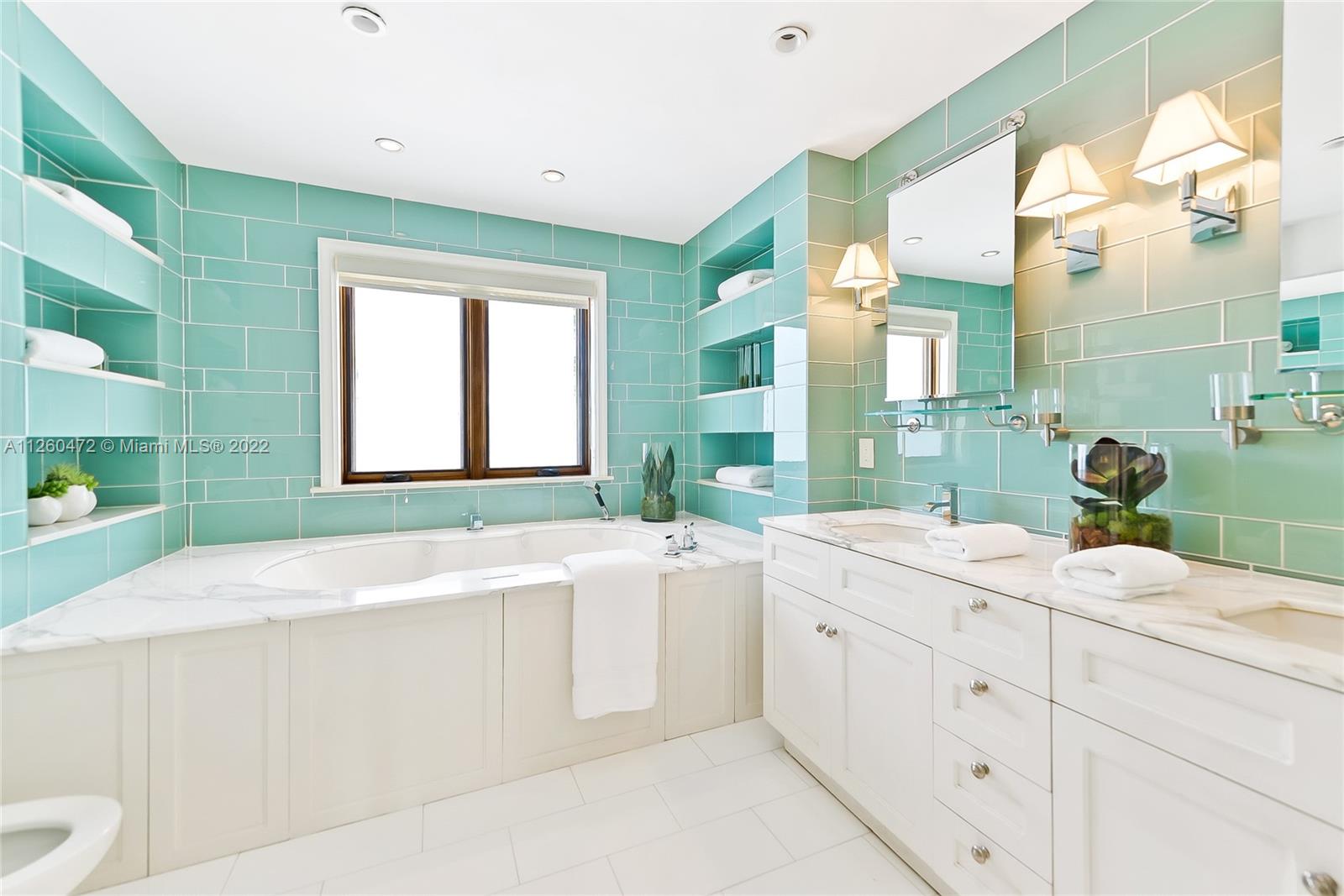 2153 North Bay Road Miami Beach, FL 33140 - Photo 15 of 19 a spacious bathroom with a sink mirror and a bathtub