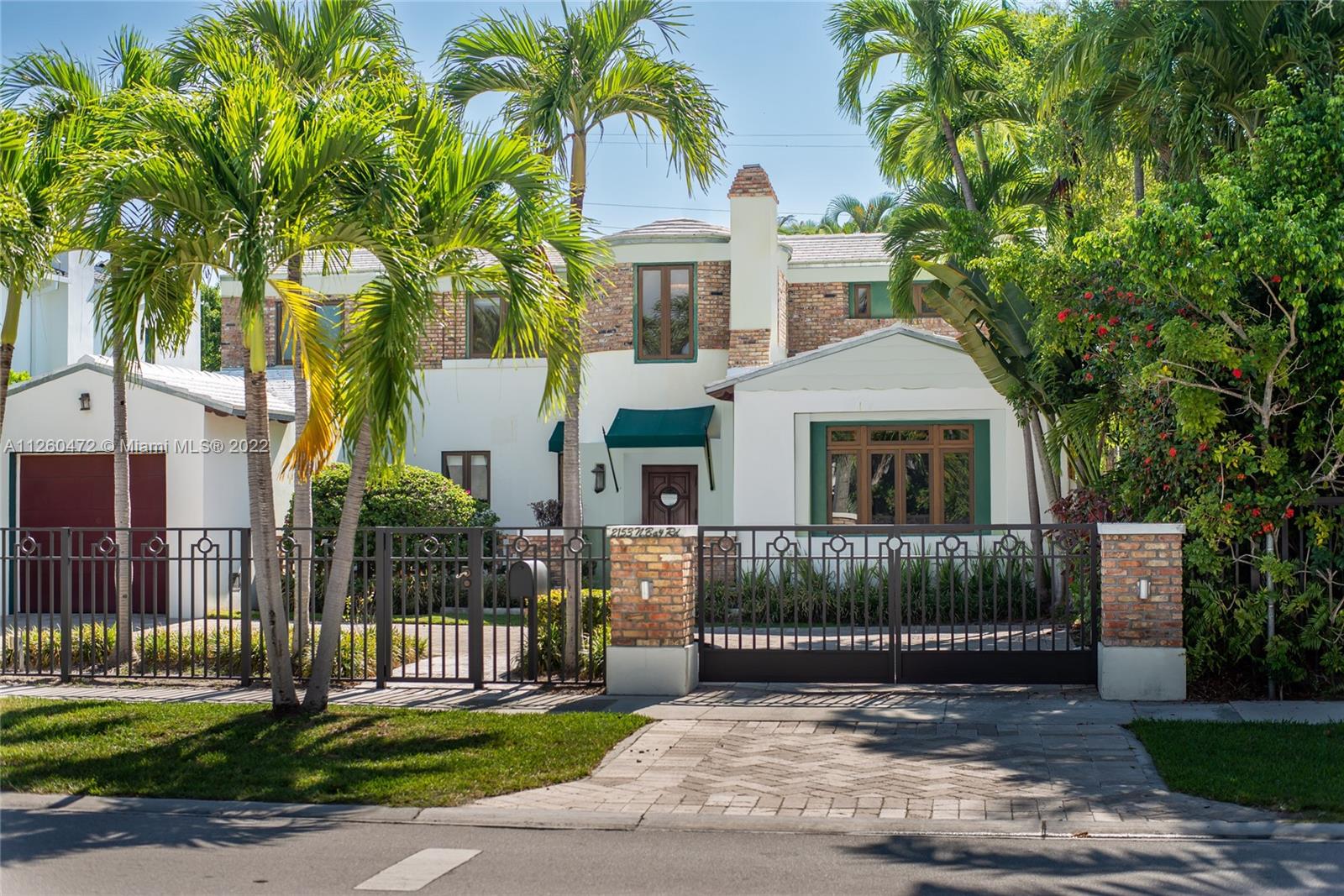 2153 North Bay Road Miami Beach, FL 33140 - Photo 16 of 19 a front view of a house with a garden and plants