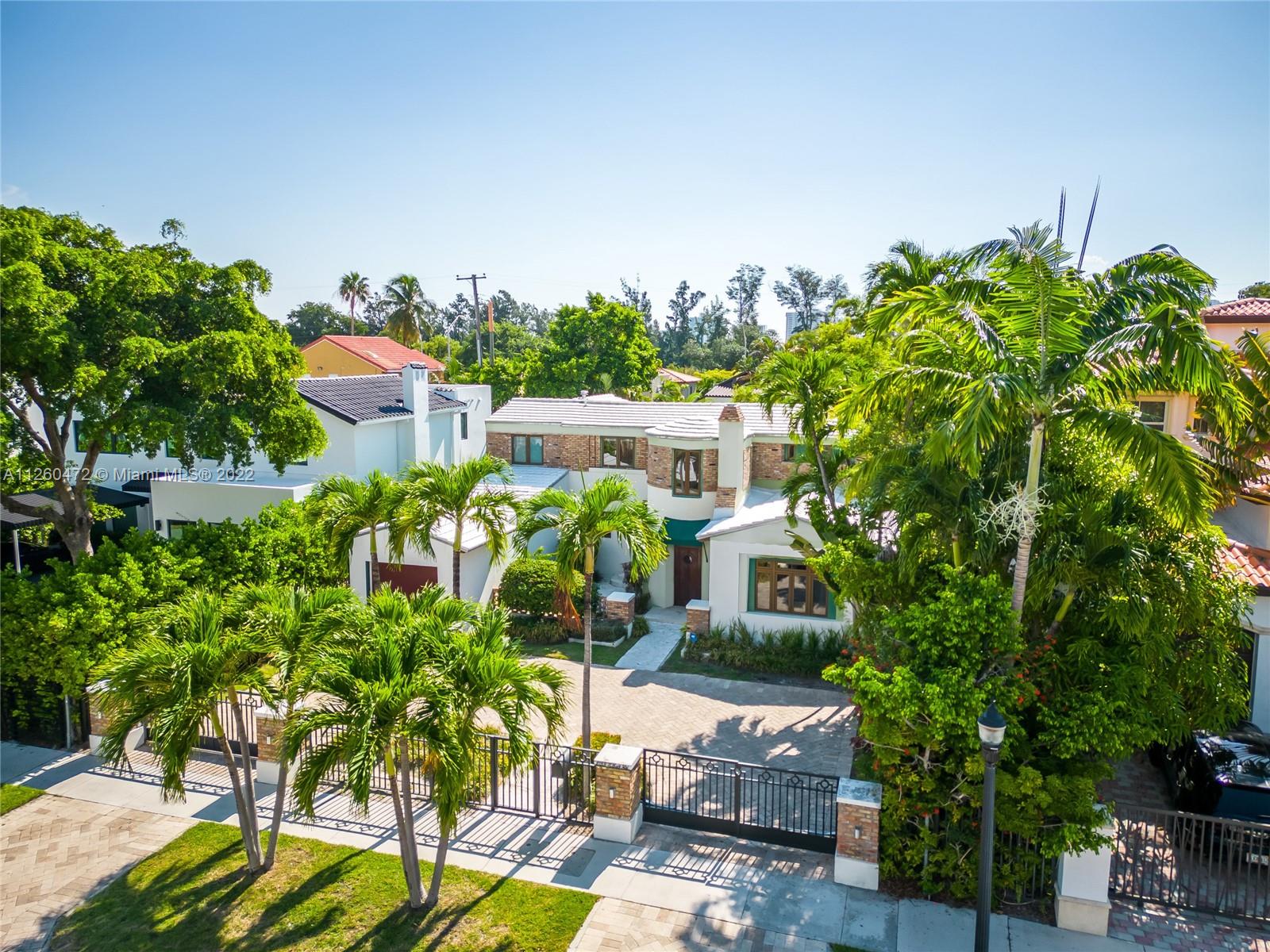 2153 North Bay Road Miami Beach, FL 33140 - Photo 17 of 19 a view of a chairs and table in a patio
