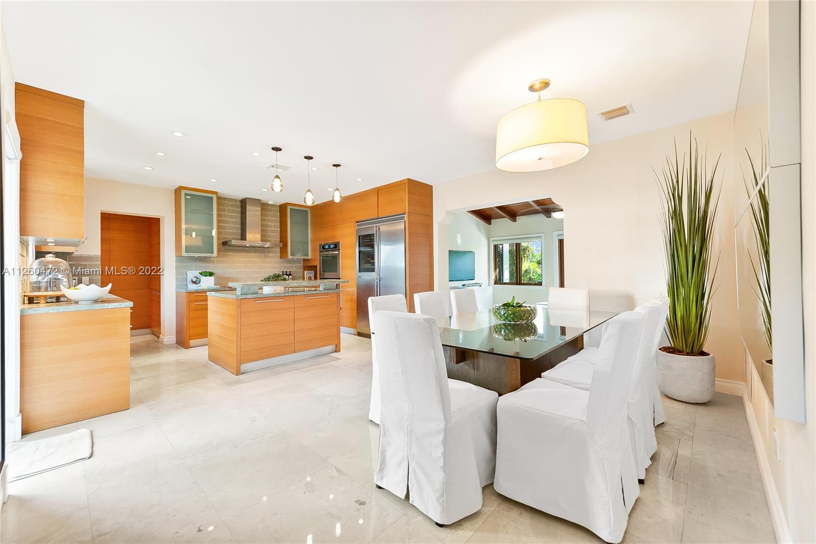 2153 North Bay Road Miami Beach, FL 33140 - Photo 5 of 19 a dining room with furniture and a kitchen view