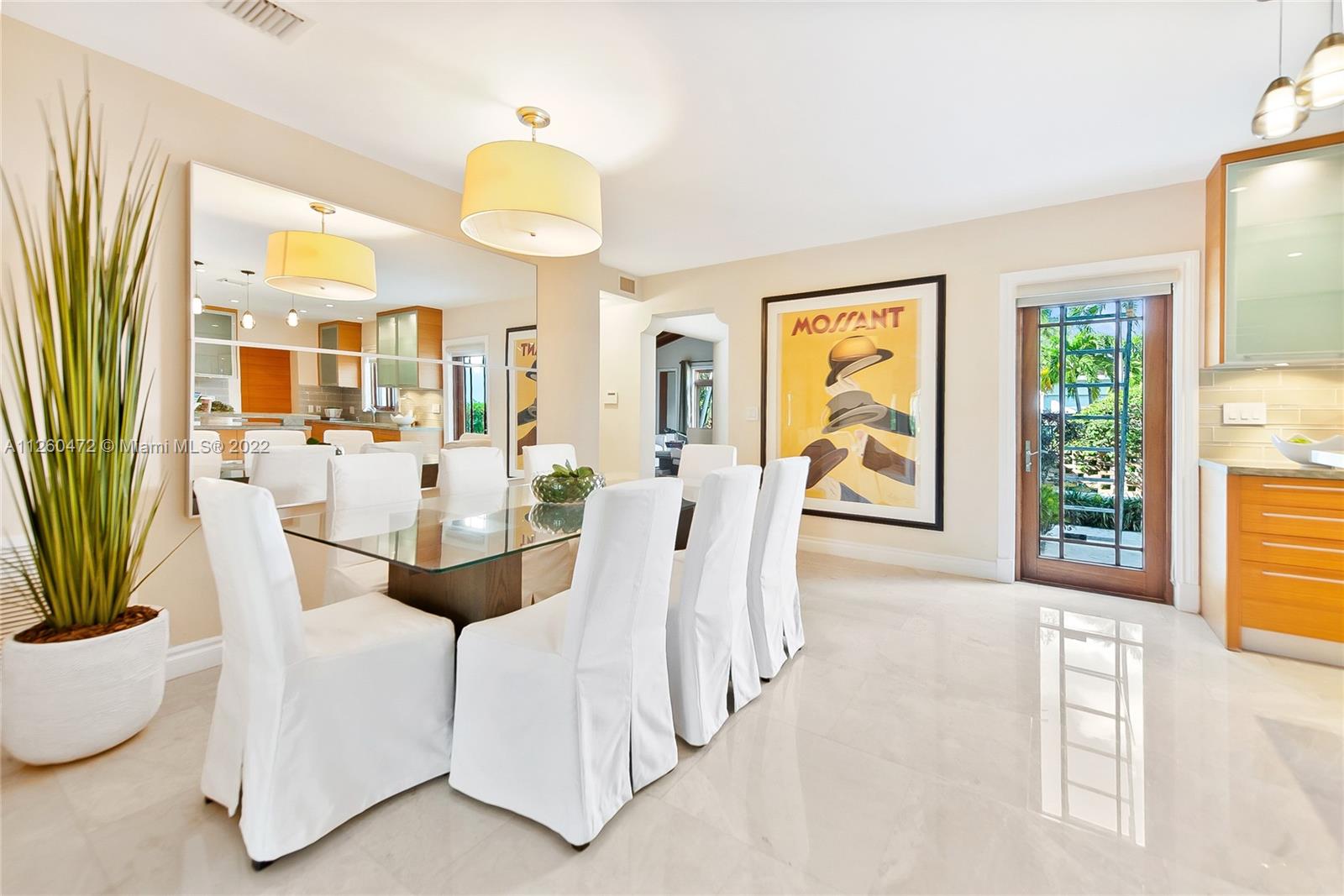 2153 North Bay Road Miami Beach, FL 33140 - Photo 6 of 19 a view of a dining room with furniture a potted plant and a chandelier