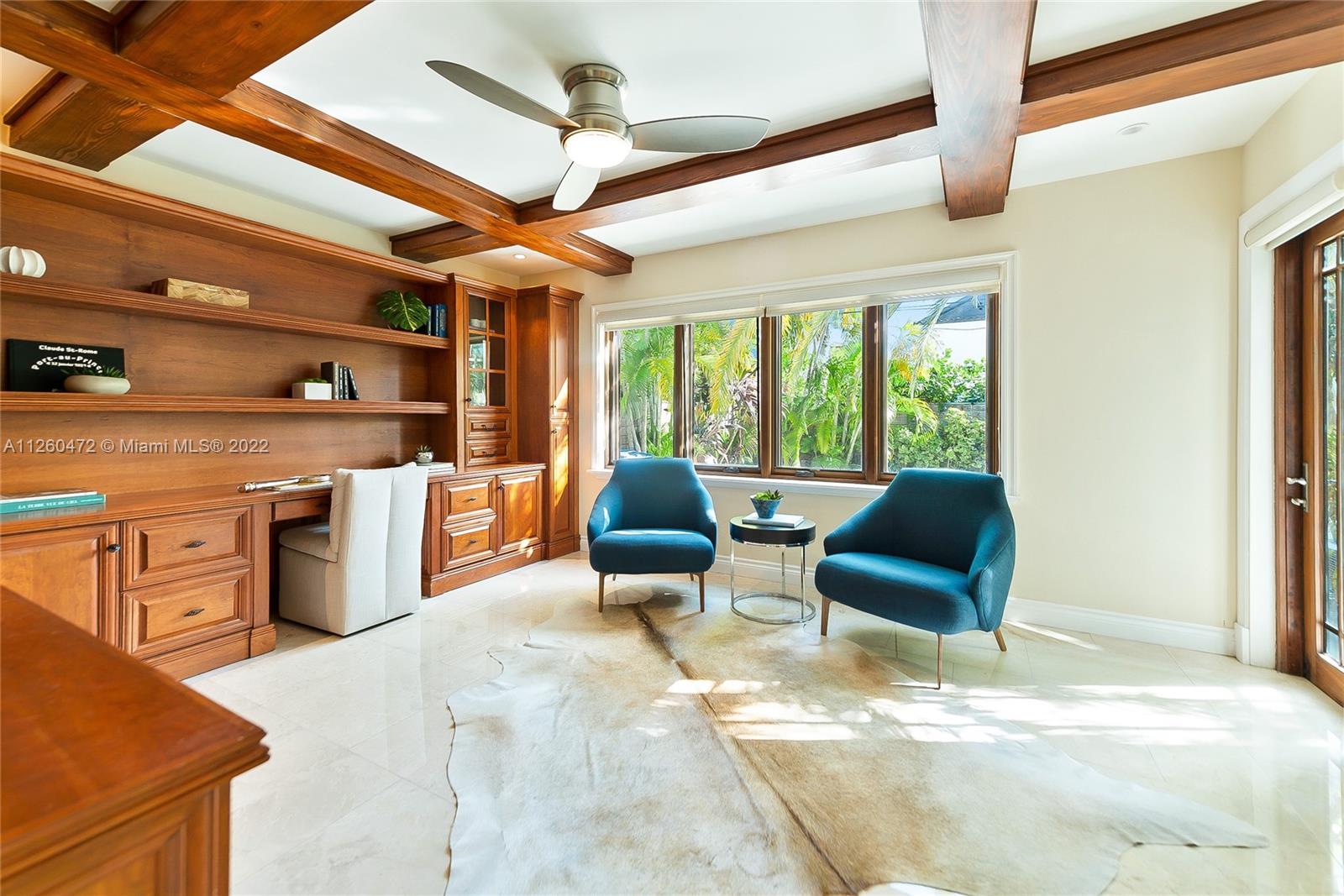 2153 North Bay Road Miami Beach, FL 33140 - Photo 8 of 19 a living room with furniture a fireplace and a ceiling fan